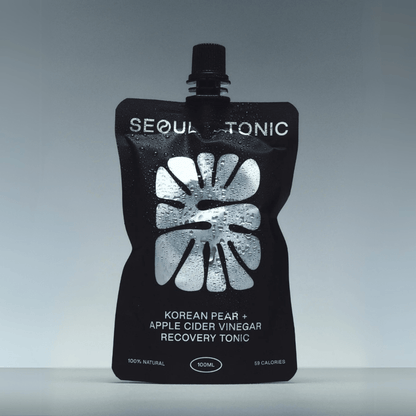 Black pouch of Seoul Tonic with white text on a gray background