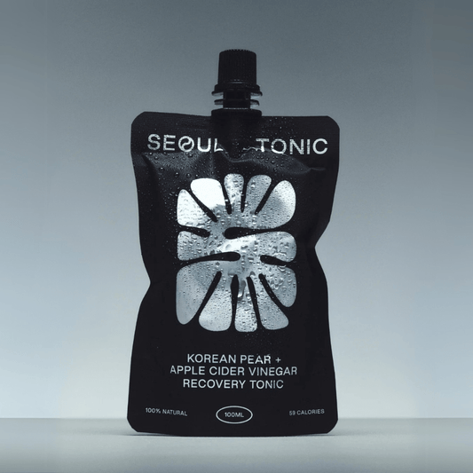 Black pouch of Seoul Tonic with white text on a gray background
